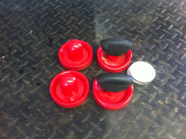 Air hockey pucks and strikers