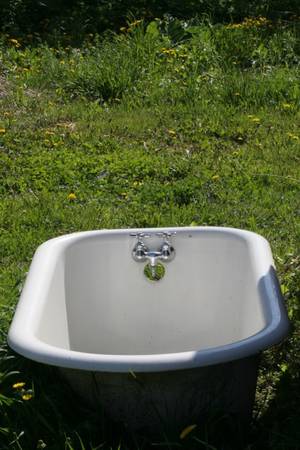 Antique claw foot tub with faucet