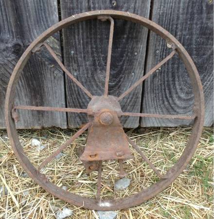 Antique Steel Wheelbarrow Wheel with the old mounting brackets.Rusty