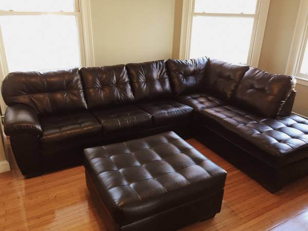 Beautiful black leather sectional with queen size memory foam mattress