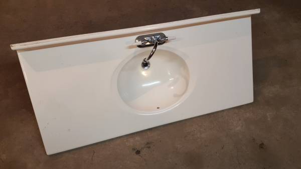 Good used condition 49 vanity top solid surface off white faucet.