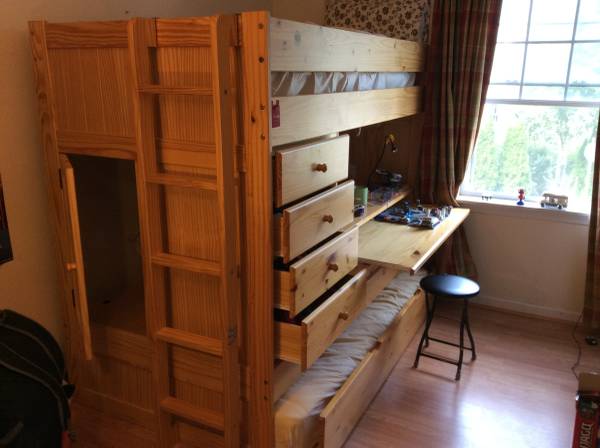 Kids loft bed with trundle, drawers, and desk