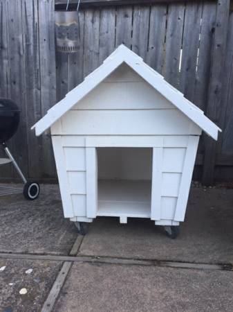 WOODEN DOG HOUSE ON WHEELS